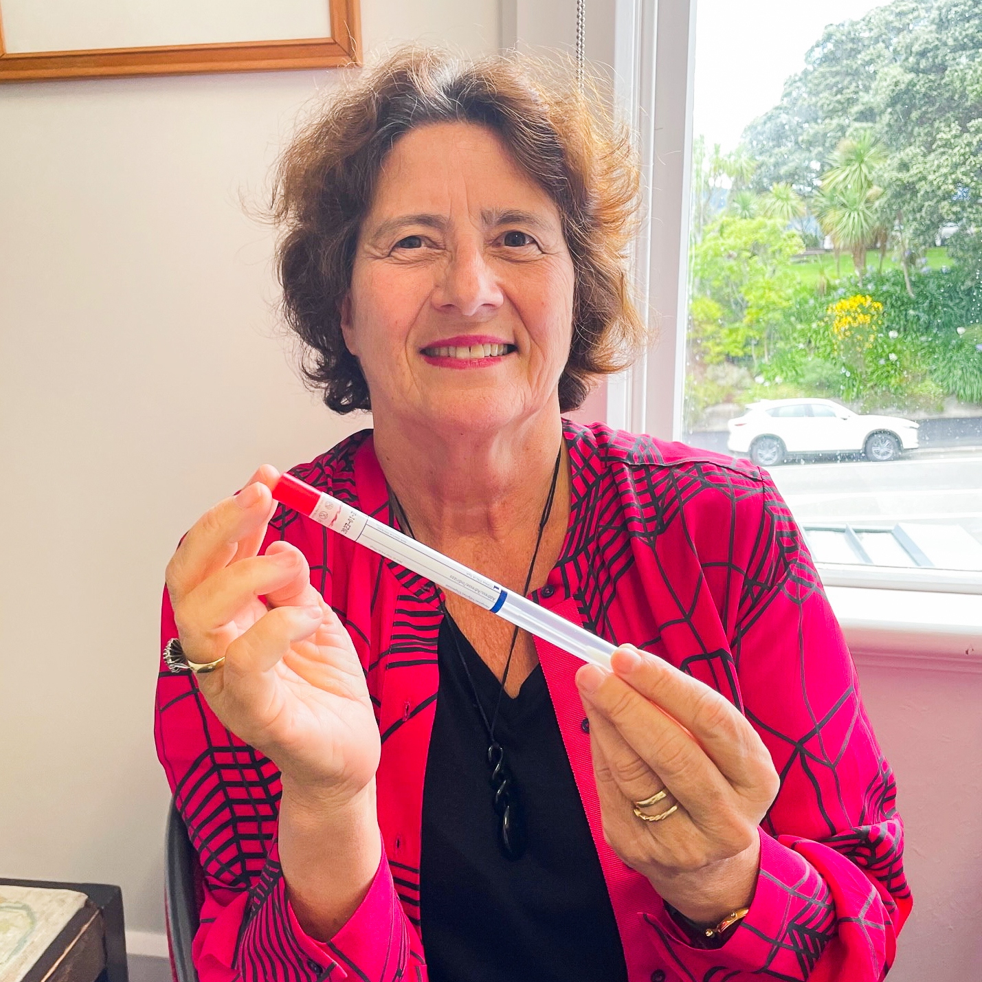 Professor Beverley Lawton holds a HPV self-testing swab