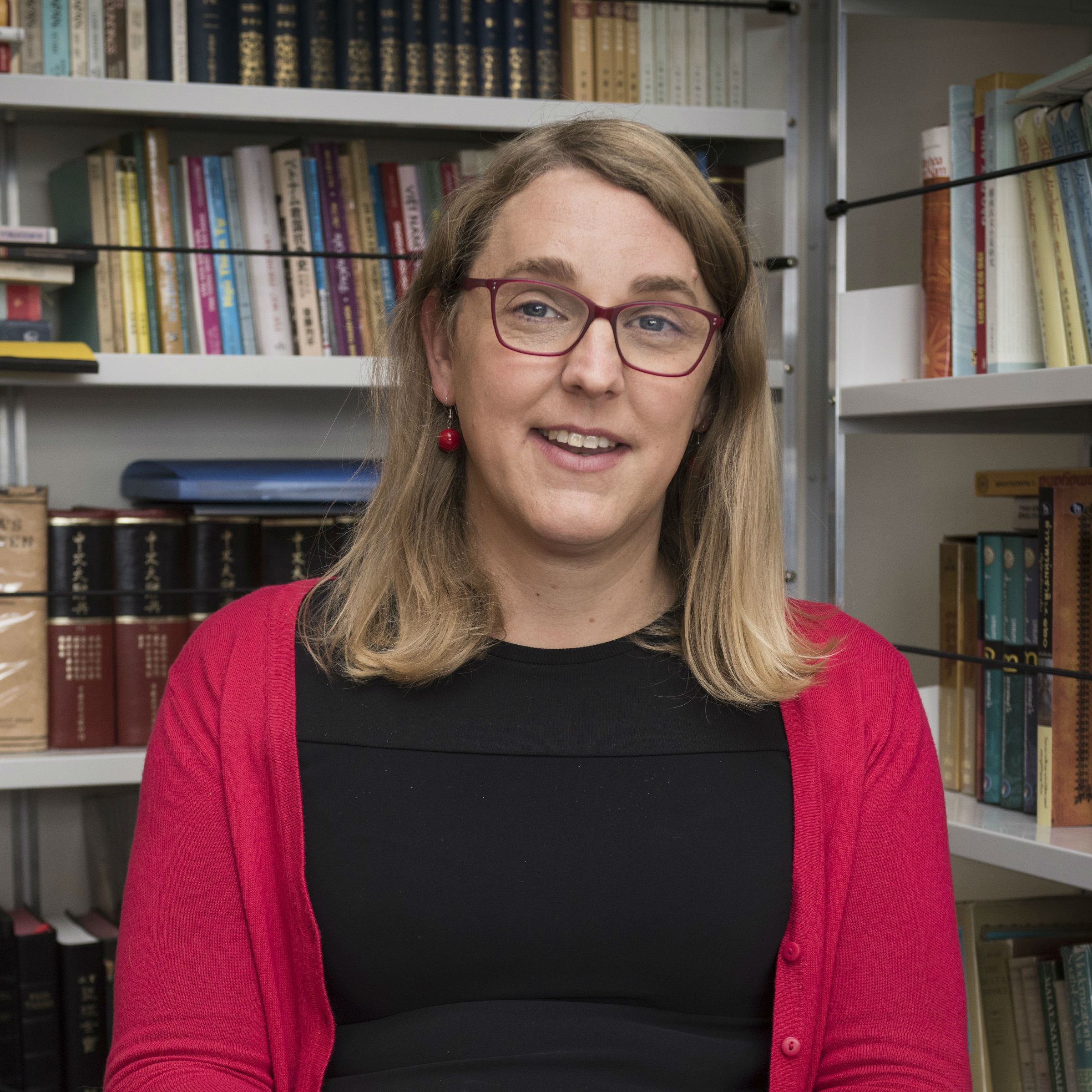 Catherine Churchman surrounded by books.
