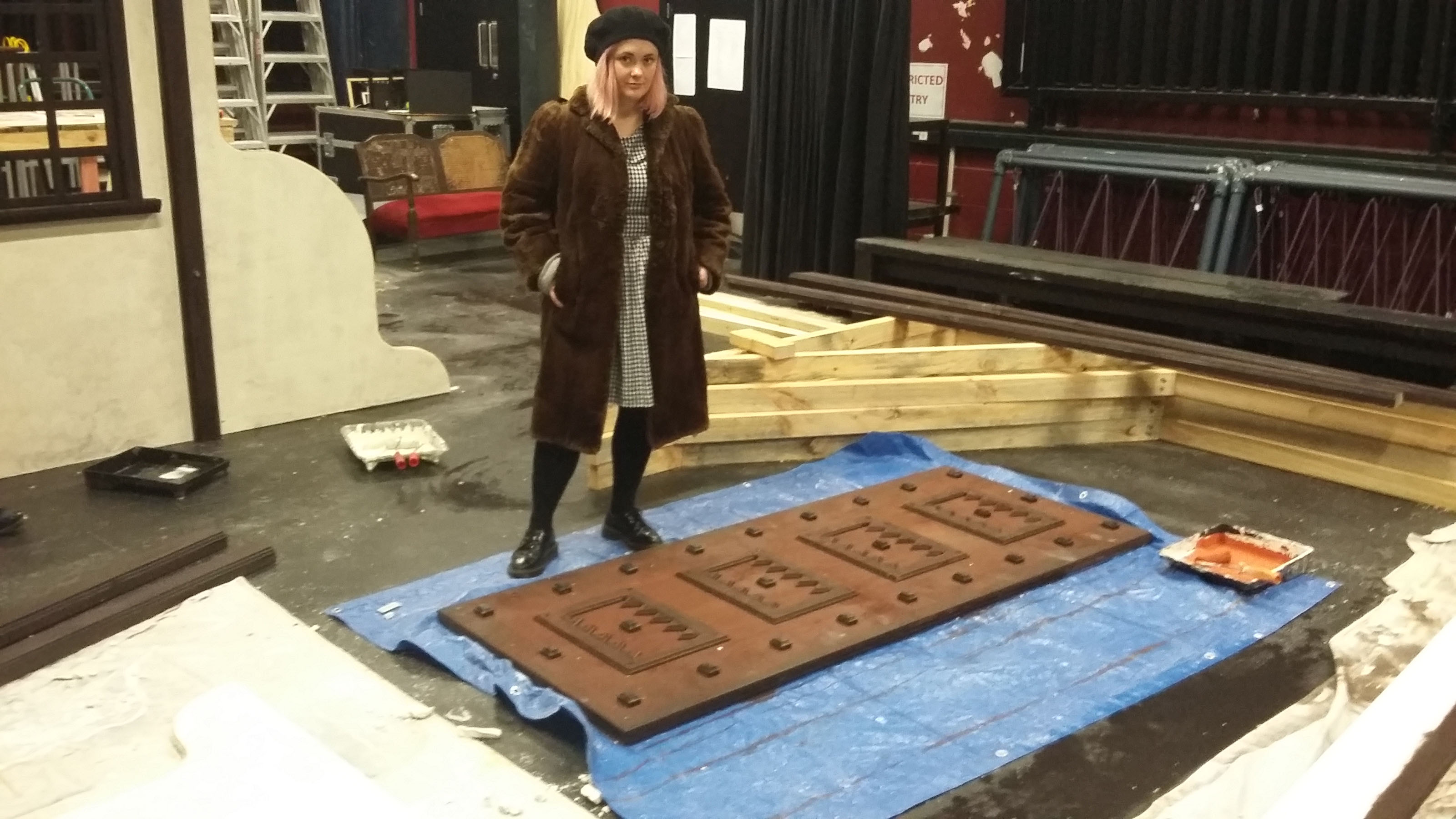 Hannah stands beside a set piece.