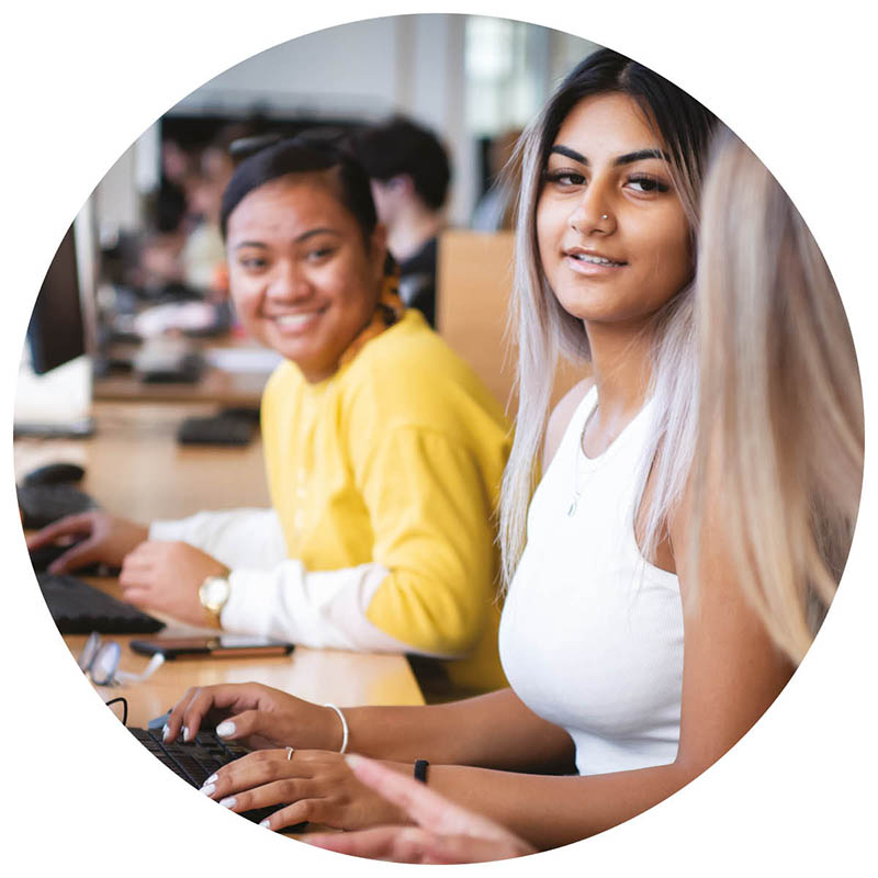 Two students seated at computers.