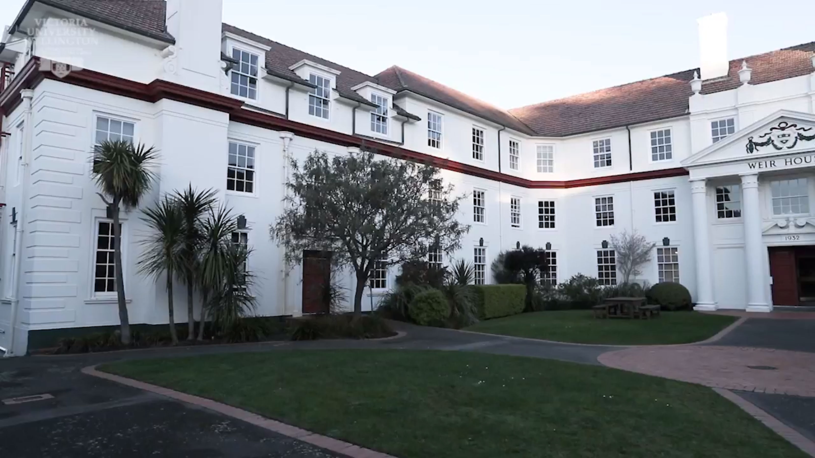 An exterior view of the main entrance to pier House – a three story building with a white exterior.