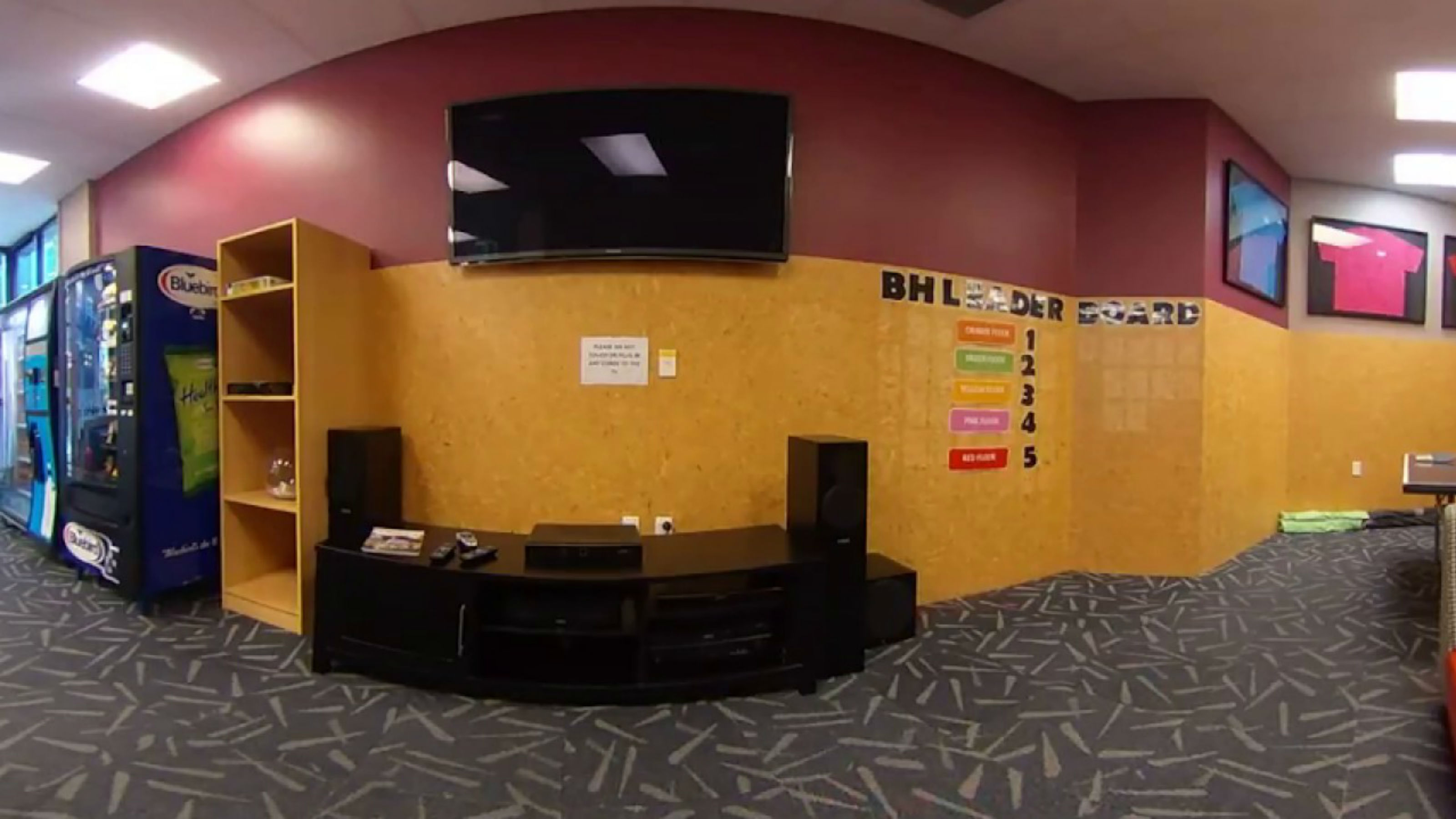A common space in Boulcott Hall with vending machines, a big tv, and a ping pong table.