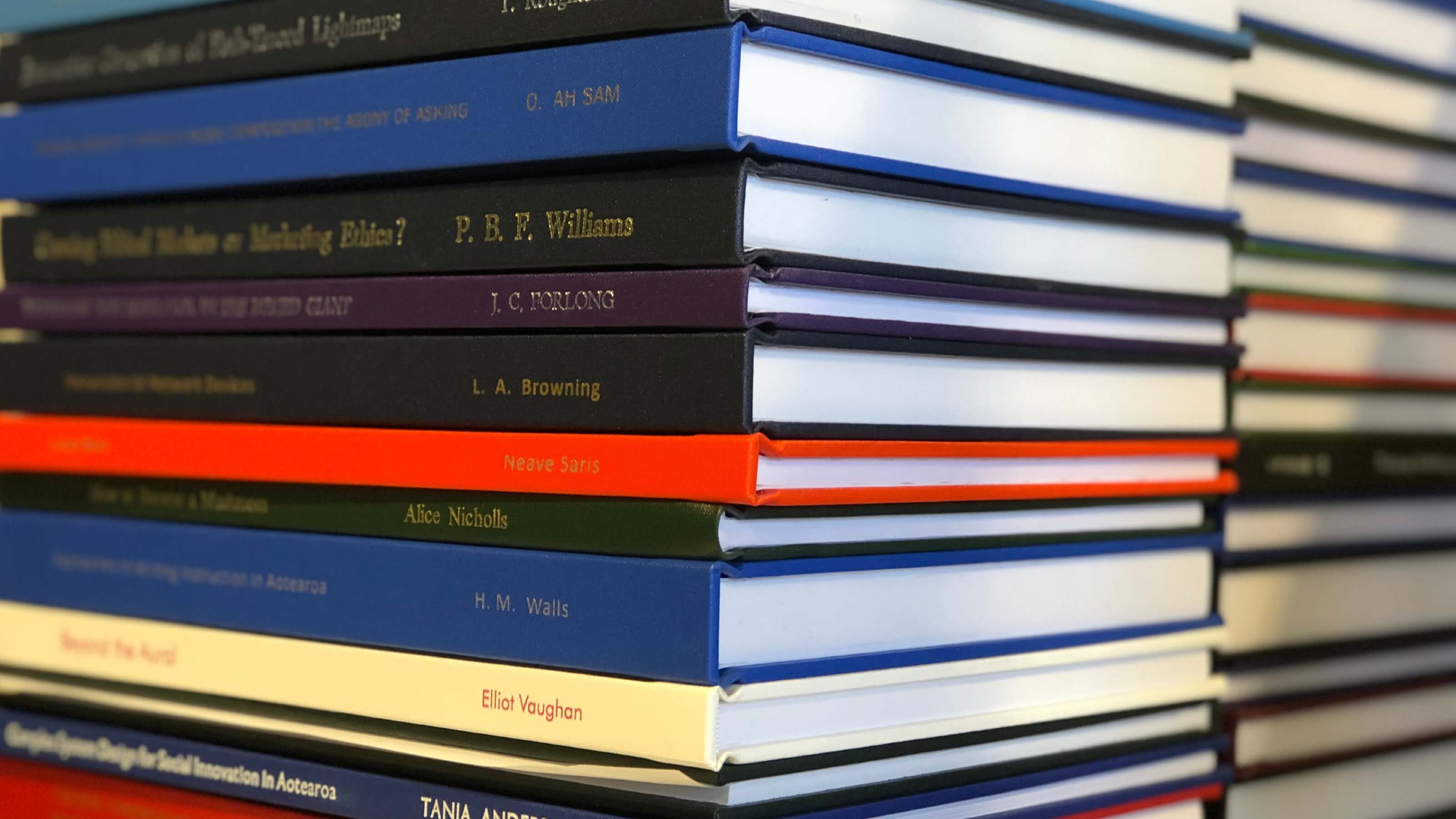 thesis-guides.jpg A close up image of a stack of hardcover books.