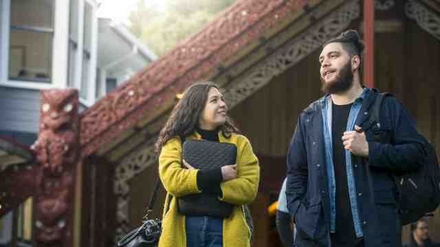 ls_small.jpg two Maori students in front of Te Herenga Waka marae