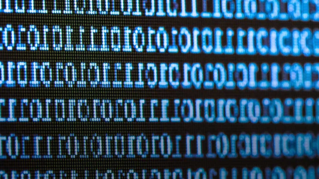 Close up image of a digital display showing ones and zeros.