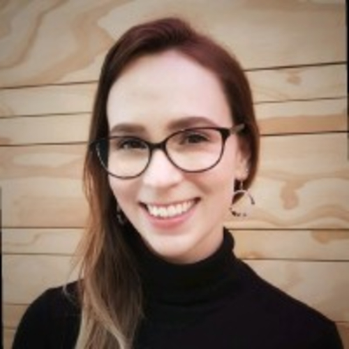 Headshot of smiling young woman with glasses