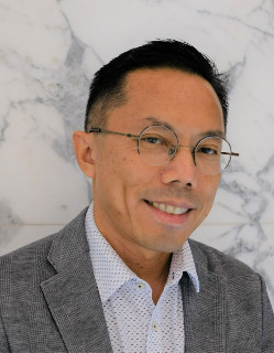 A profile image of Dr Chan-Hoong Leong, wearing a grey suit.