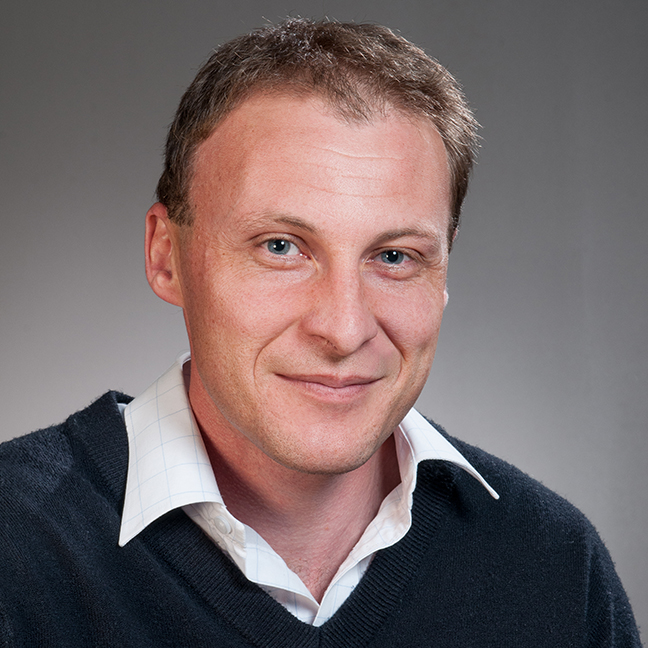 Dr Jason Young faces the camera in a head and shoulders shot.