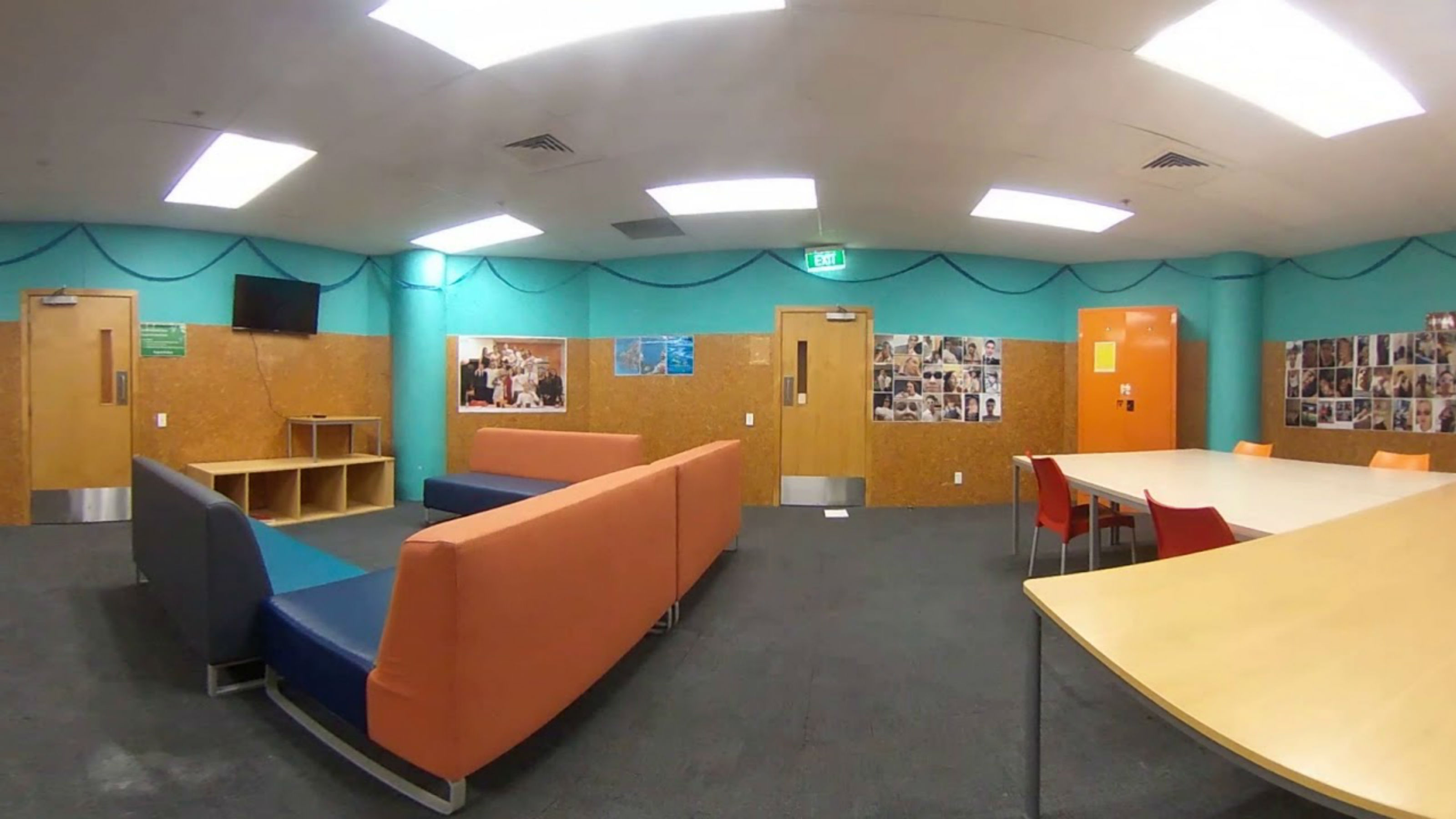 Joan Stevens Hall common room with television and sofas.