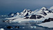 An image of a mountain covered in ice by the sea.