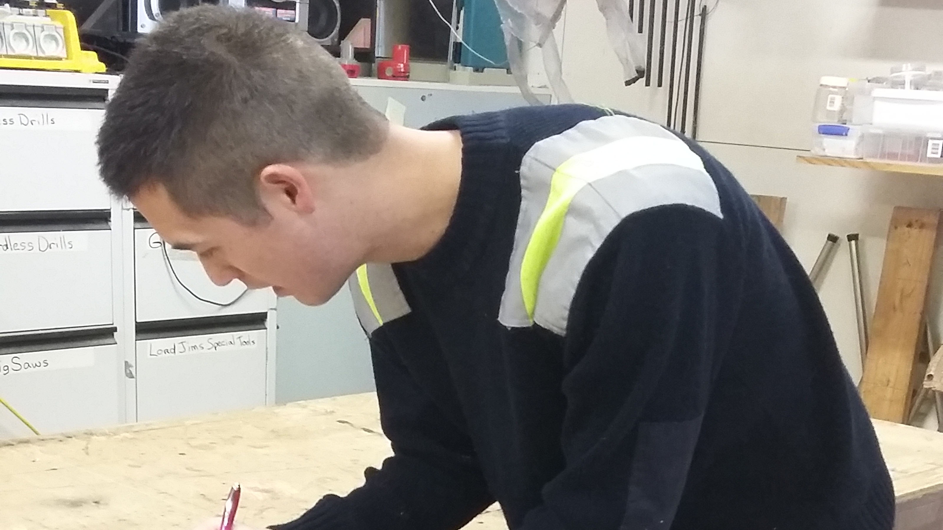 Tiernan concentrates on writing something.