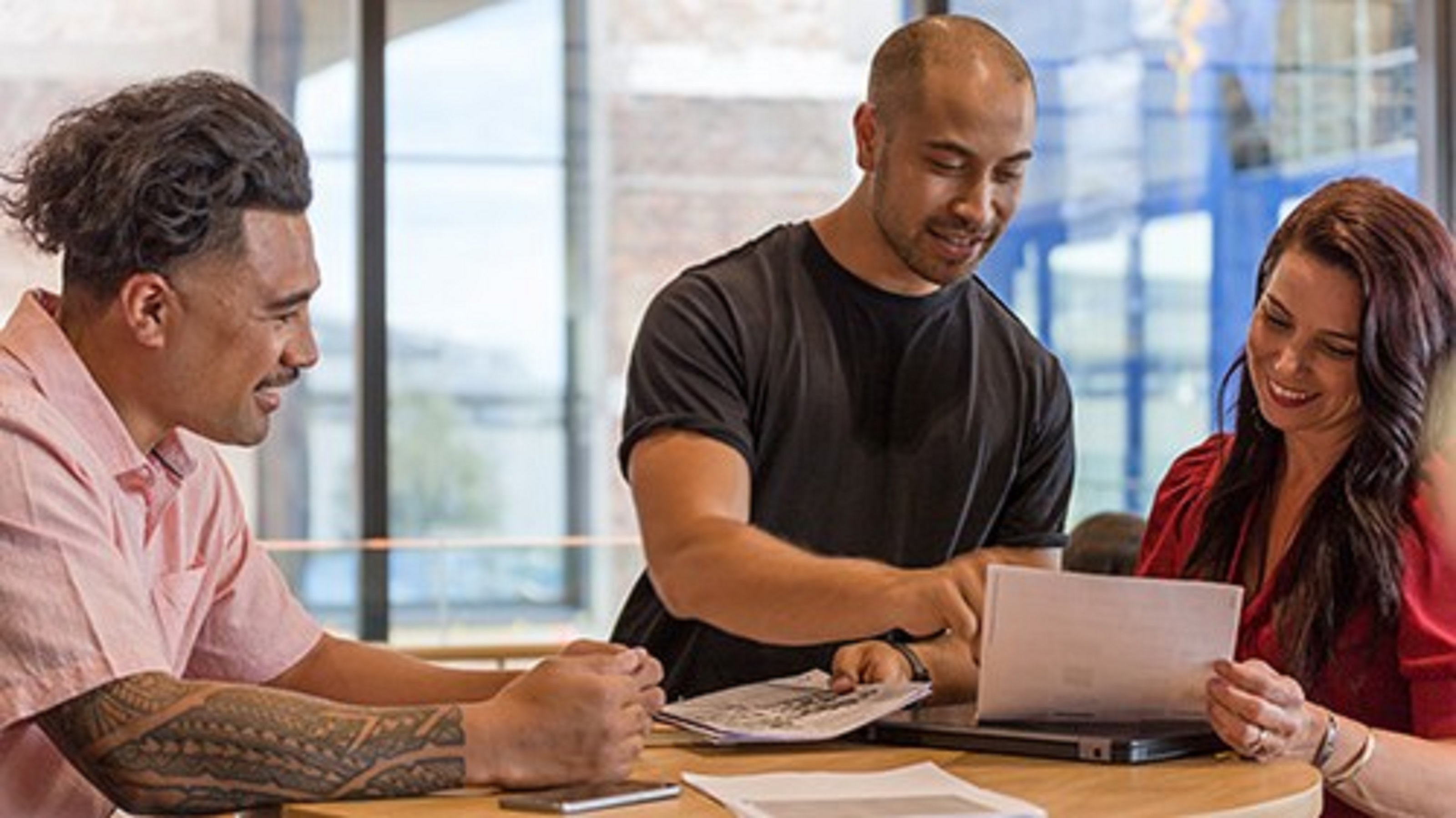 Three people working together at table 