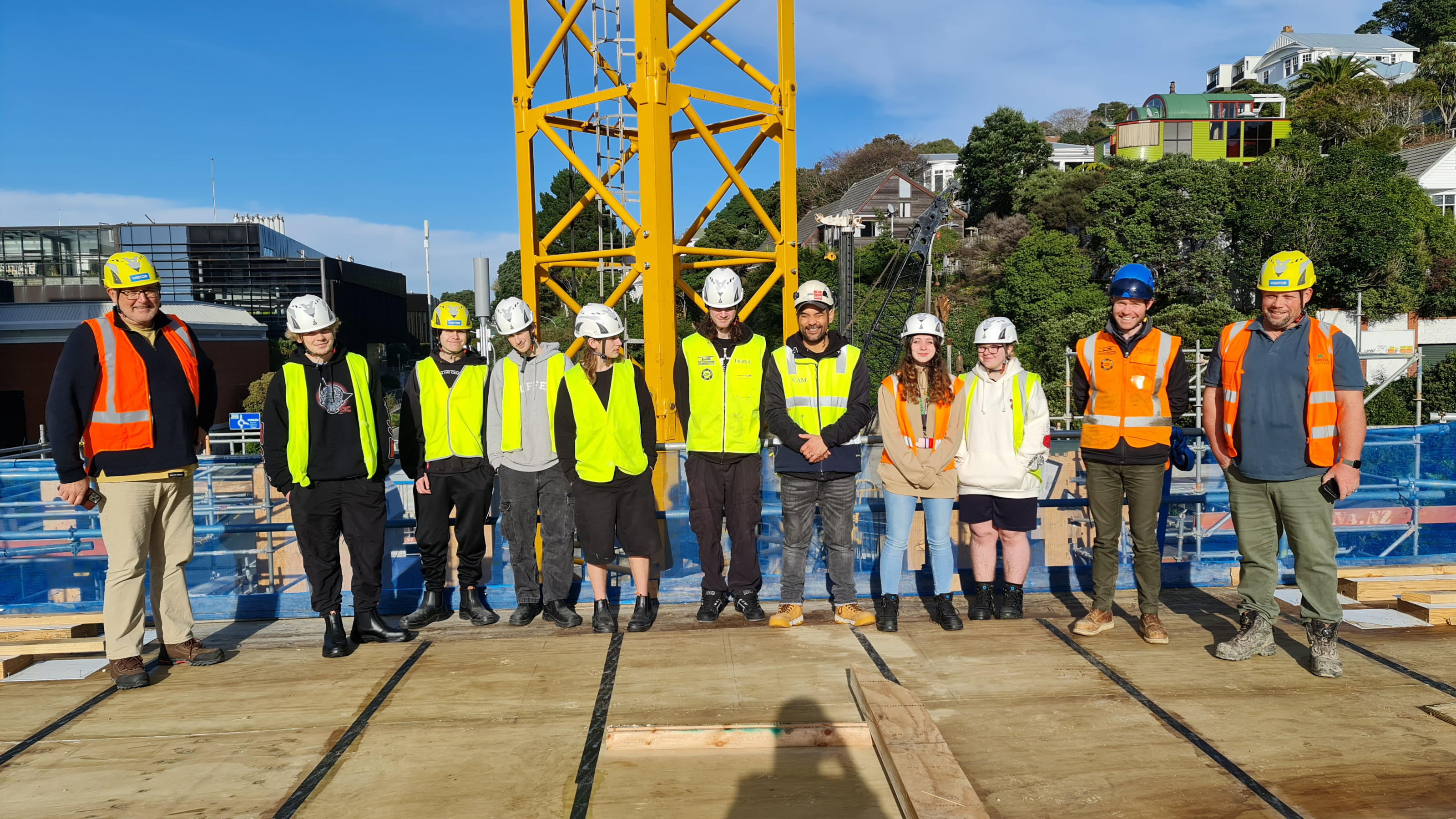A group of people in hi vis vests and hard hats on a construction site.