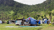 Rural setting with a dilapidated building and tent marquee