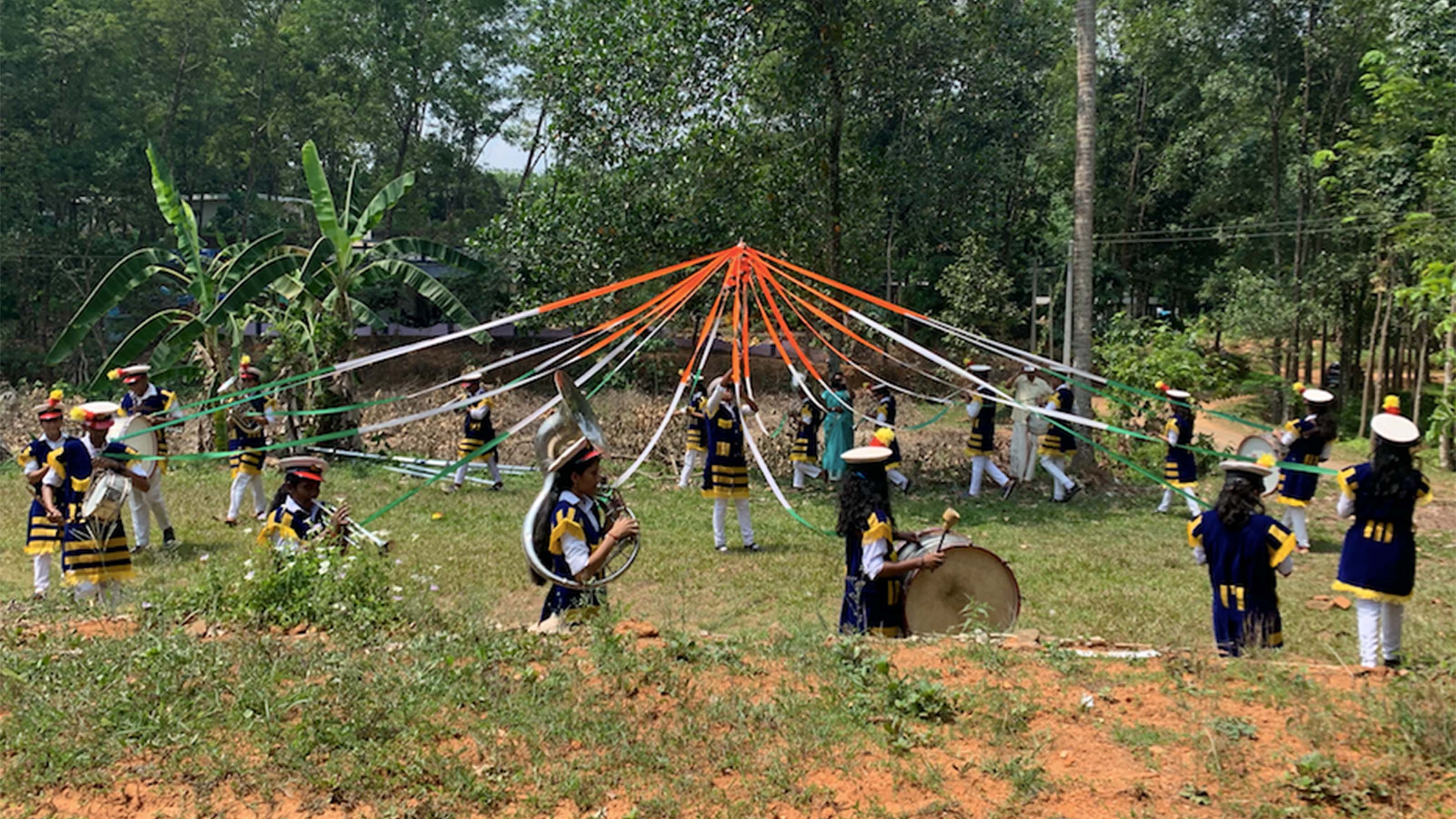 School marching band at Thodupuzha marching around a flagpole