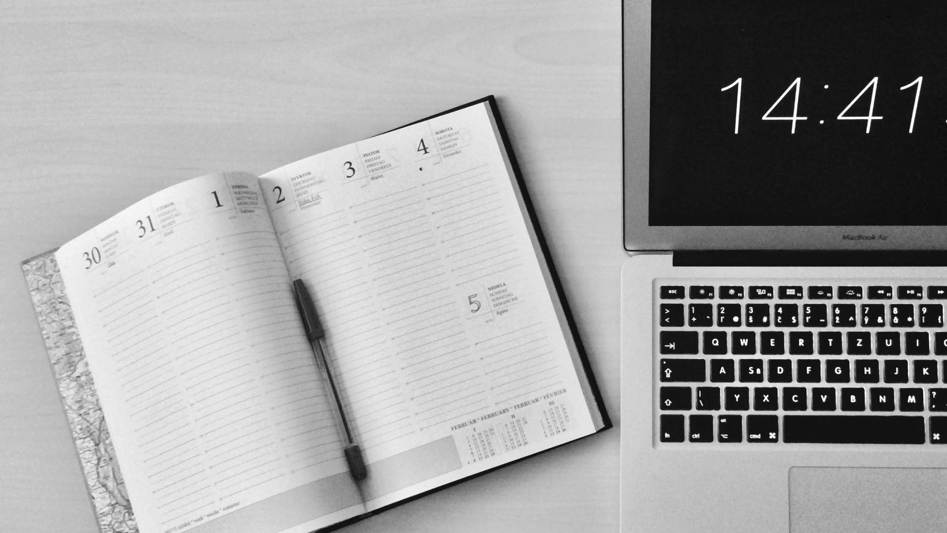 research-consultation.jpg An open schedule the a pen and a laptop on a desk.