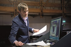 Robert Legg from NZSM lecturing in front of computer with screen behind