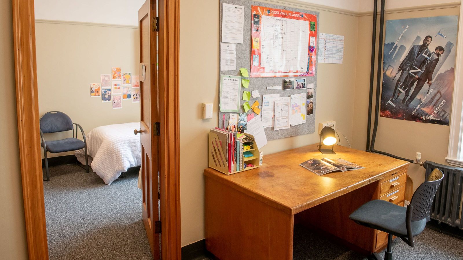 Set room in the William Weir Wing at Weir House, with a desk, and a bed and chair visible through a doorway.