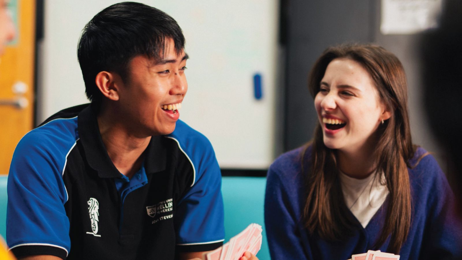 An Resident Adviser chatting and laughing with a resident.