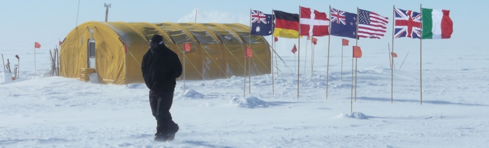 A research hut in the Antarctic with seven flags.