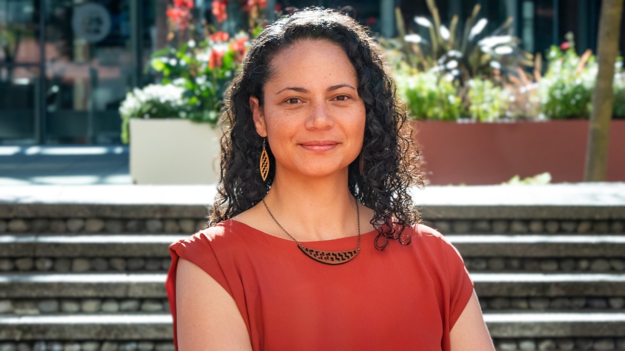 Photo of Chevelle Ataera in graduation robes