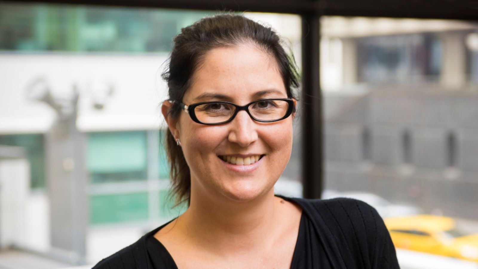 Haley Ataera.jpg Head and shoulders portrait of Haley Ataera smiling at the camera. Haley wears glasses and a black top and has brown hair pulled back in a ponytail.