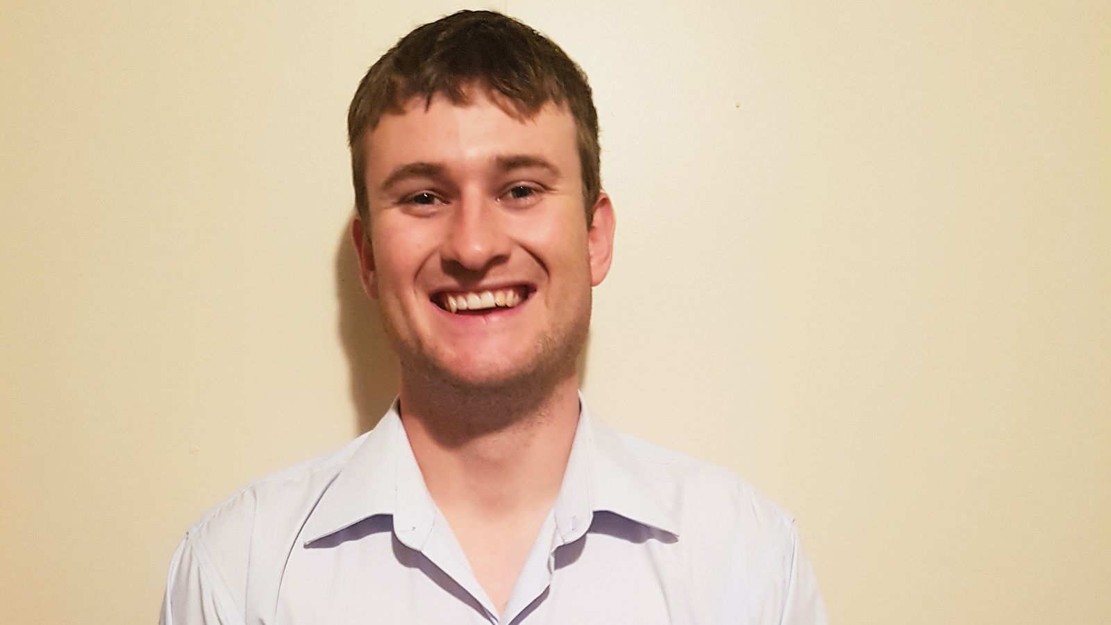 Brad White.jpg Head and shoulders portrait of Brad. Brad wears a white shirt and smiles at the camera.