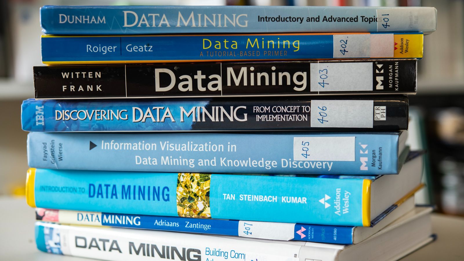 Data mining books Stack of books whose spines all have titles referring to data mining