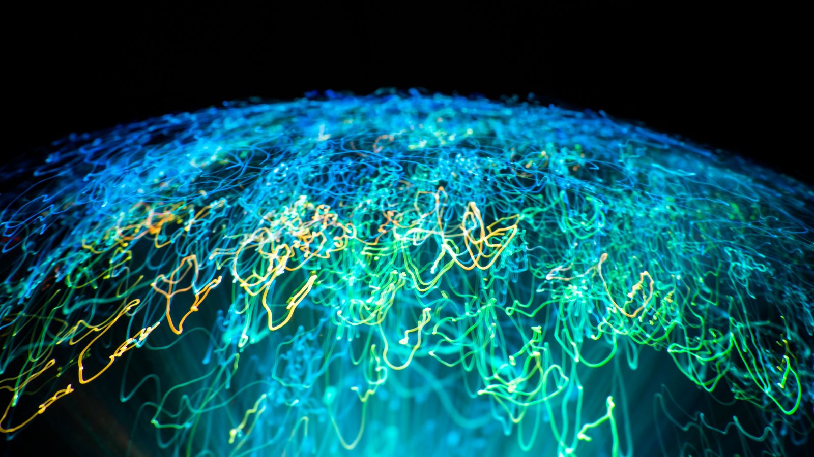 Digital planet Scribbly lights in a globe shape against a dark background