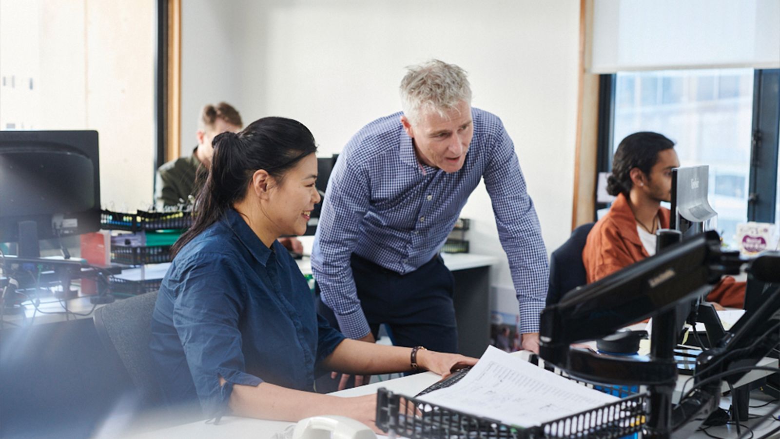 A woman and man looking at a computer screen