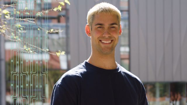 A young man smiling directly at the camera.