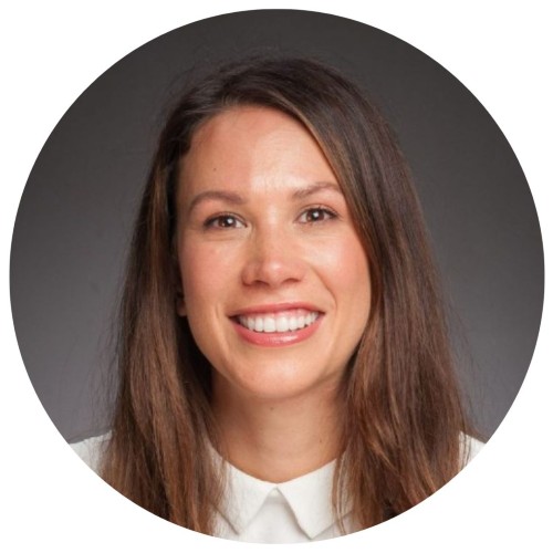 Woman with dark brown hair smiling.