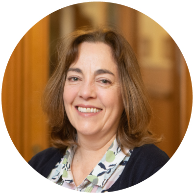 Woman with short brown hair smiling.