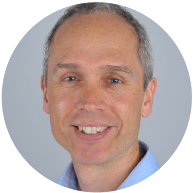 Grey haired man smiling. 