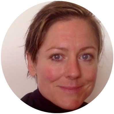 Woman with short brown and blonde hair smiling 