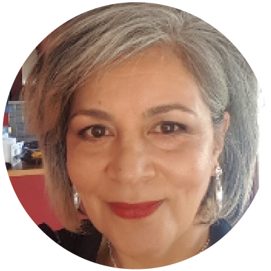 Woman with grey hair and red lipstick smiling.