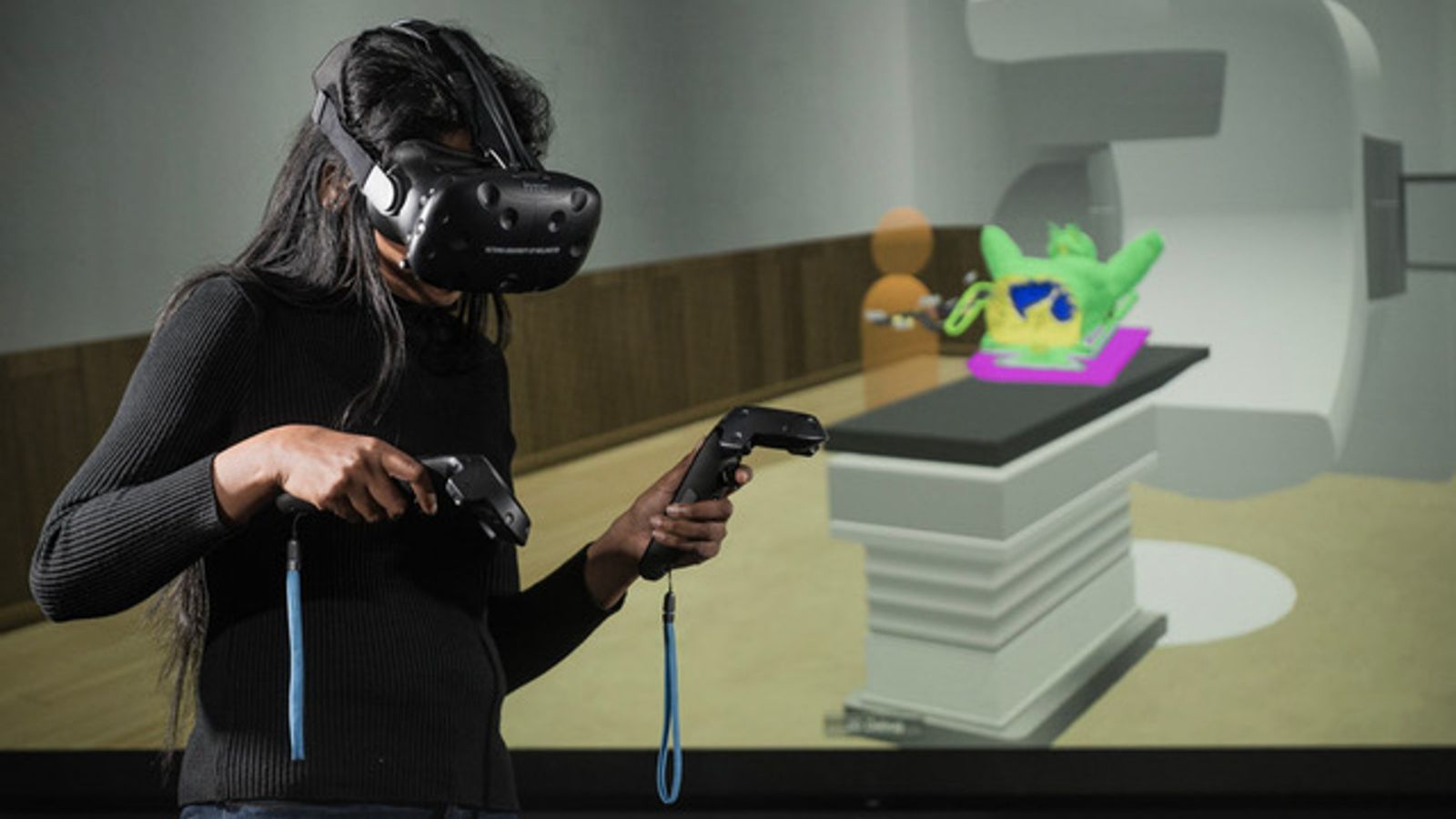 A person using a virtual reality device to learn how to use an MRI machine