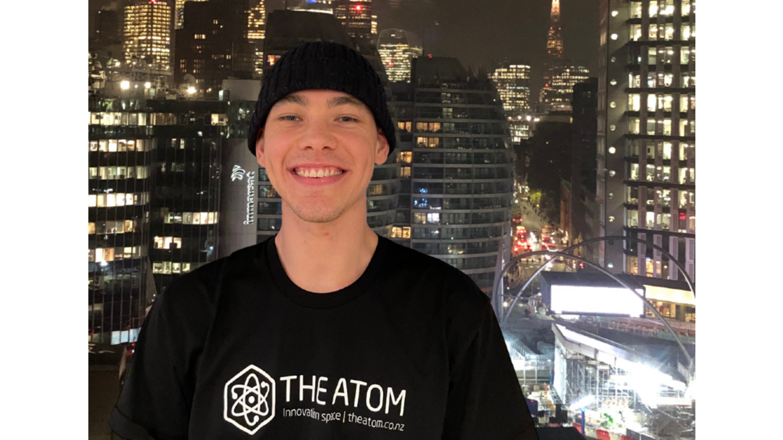 Griffin Lilley Man in black beanie and hoodie with night city background