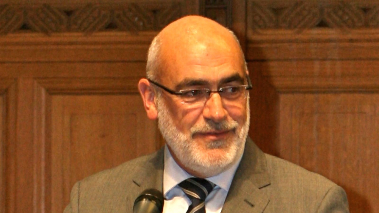 Professor Tim McCormack stands at a microphone