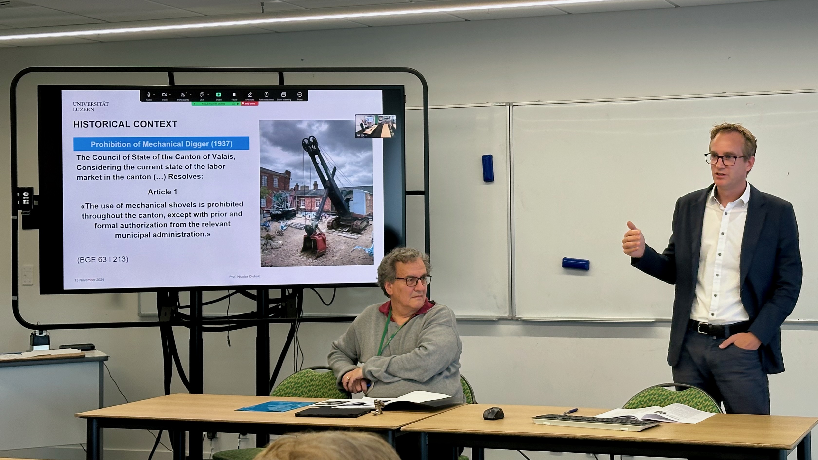 A Photo of Nicolas Diebold presenting at the Symposium on Economic Freedom