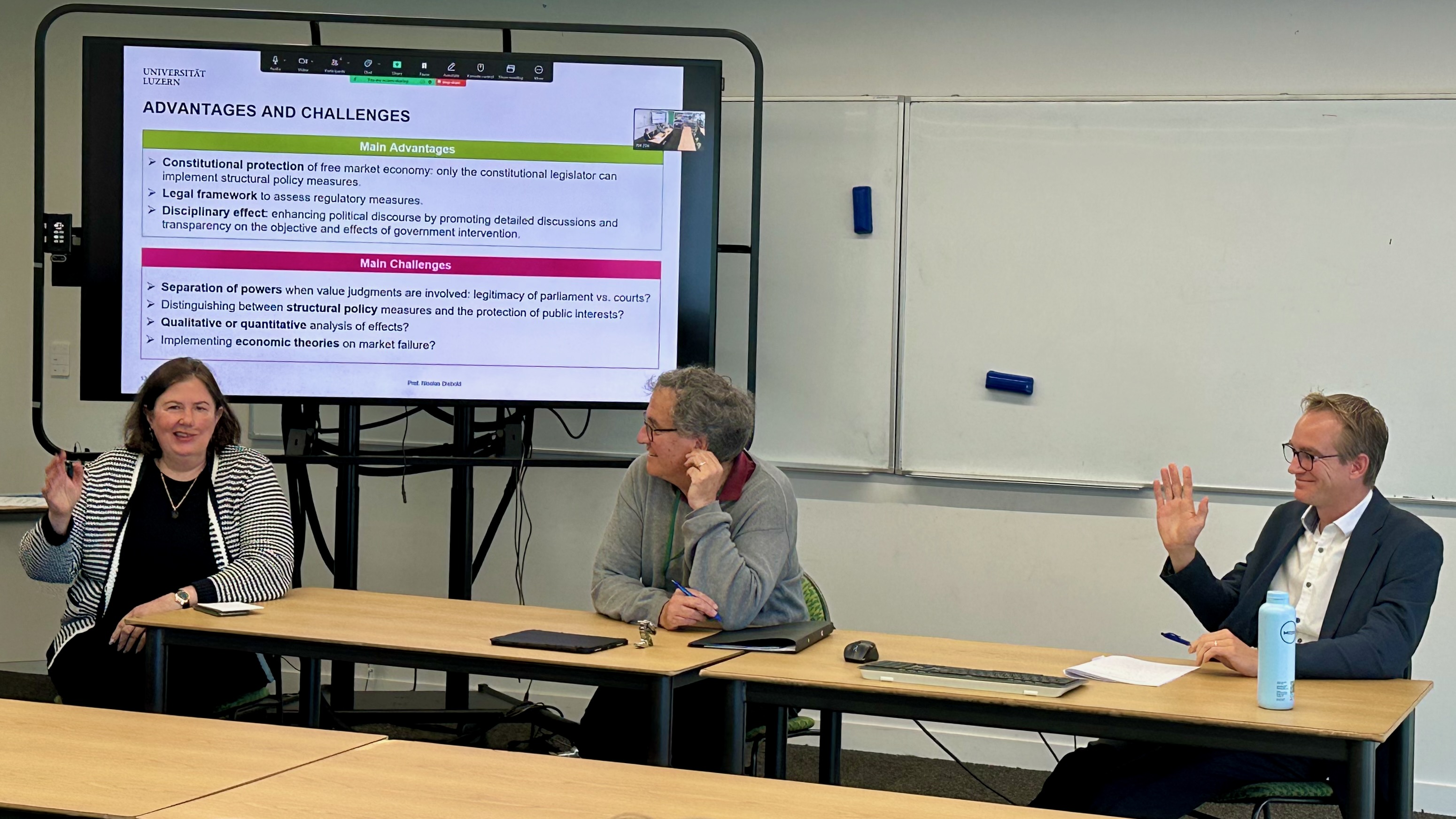 A Photo of Susy Frankel et al presenting at the Symposium on Economic Freedom