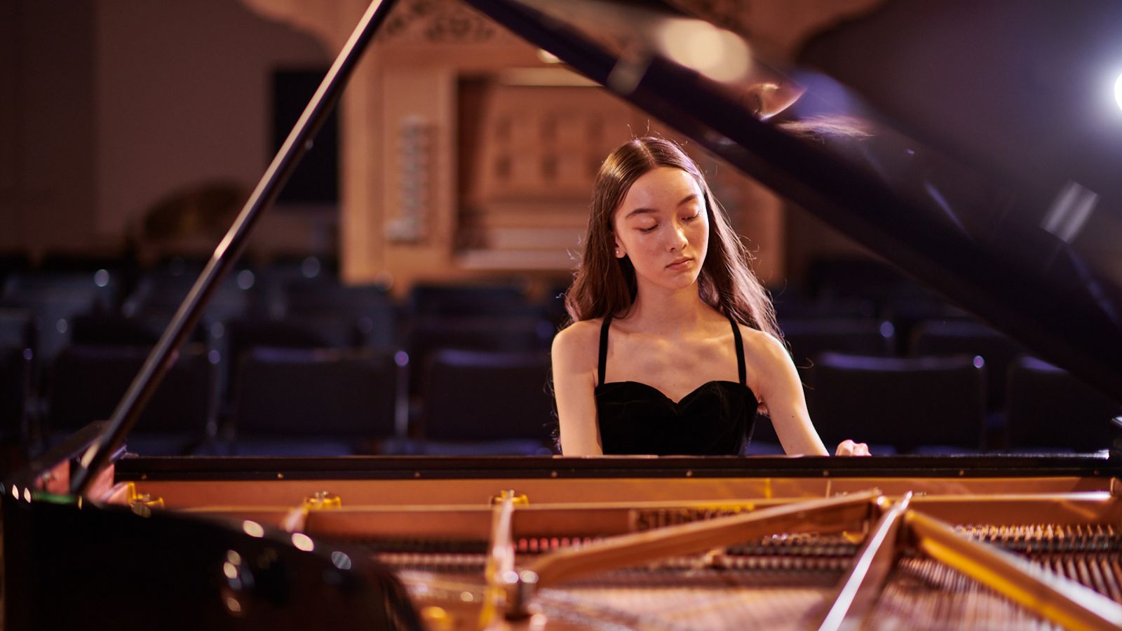 A student playing the piano.