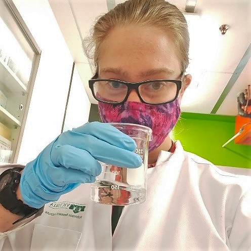 Sophie Banks cleaning samples from magnetron sputtering machine