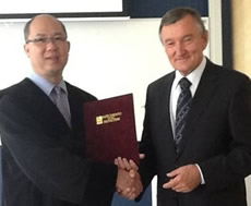 Professor Fam shakes hand with the Rector, Professor Tamas Szekeres