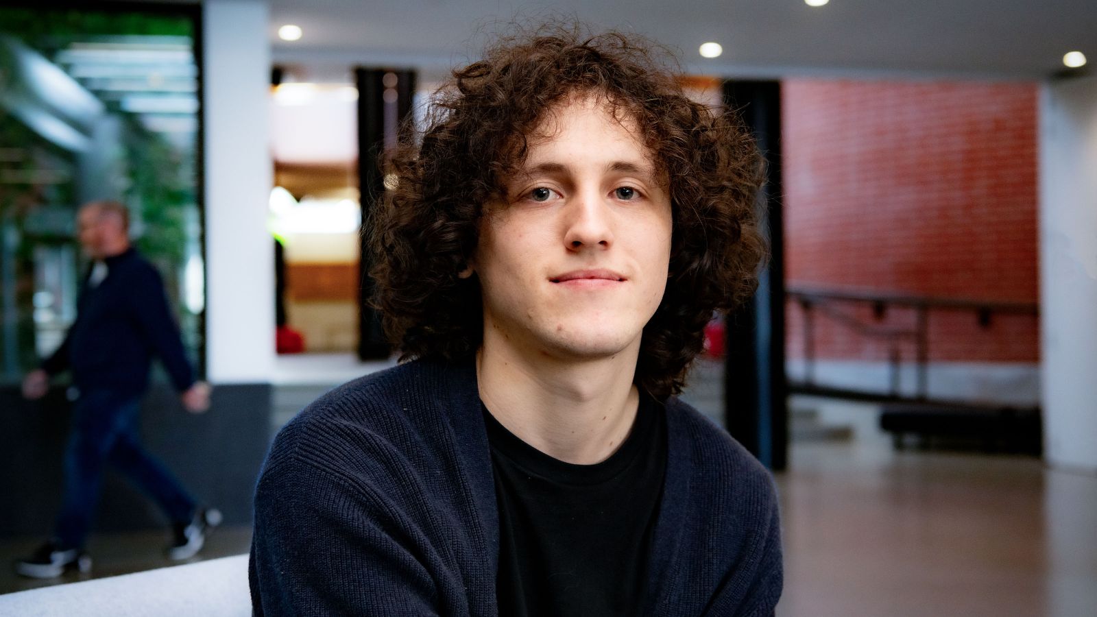 Ryan Thompson Ryan Thompson, with curly and voluminous hair, smiling.
