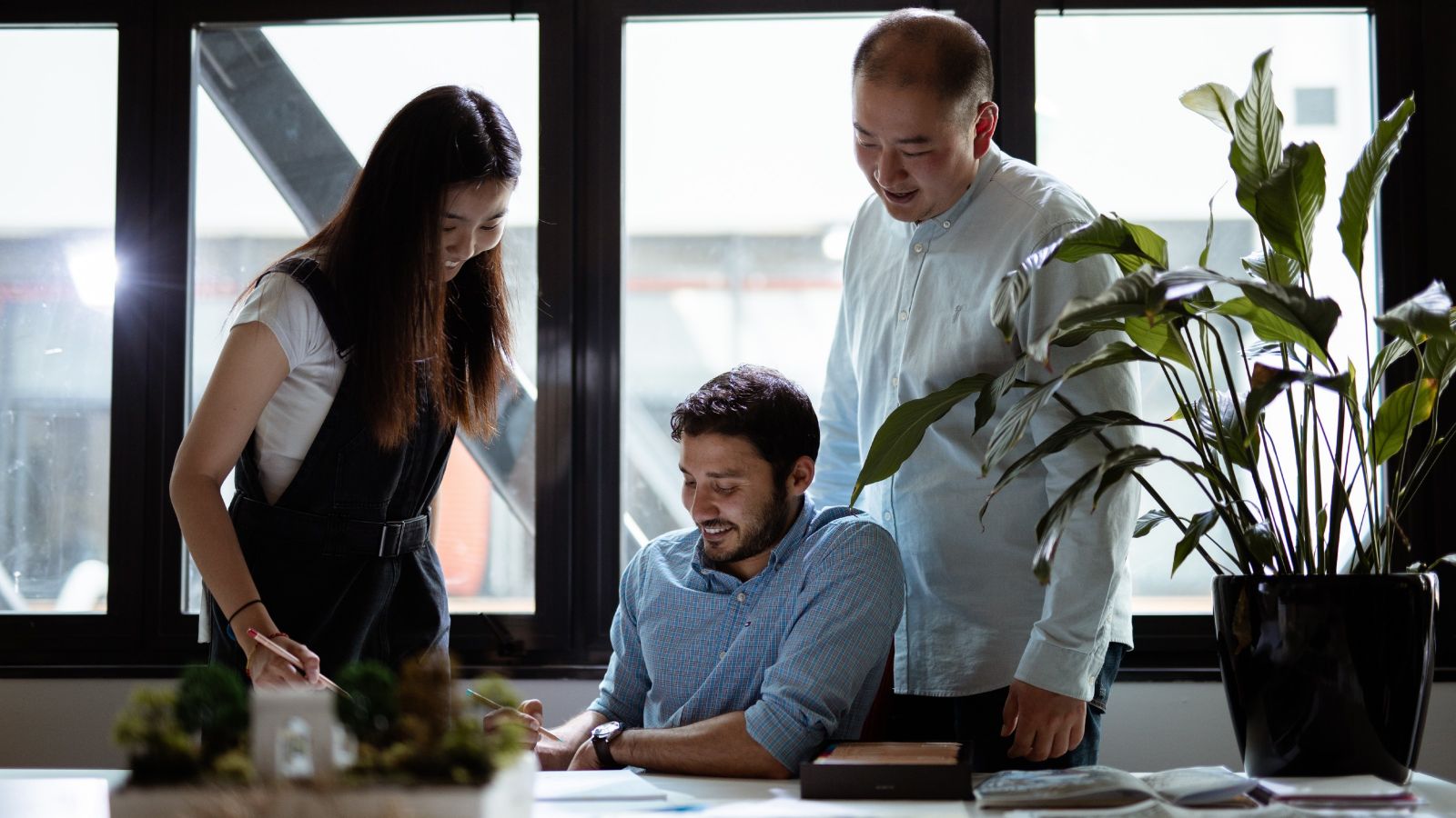 Three people working in a studio